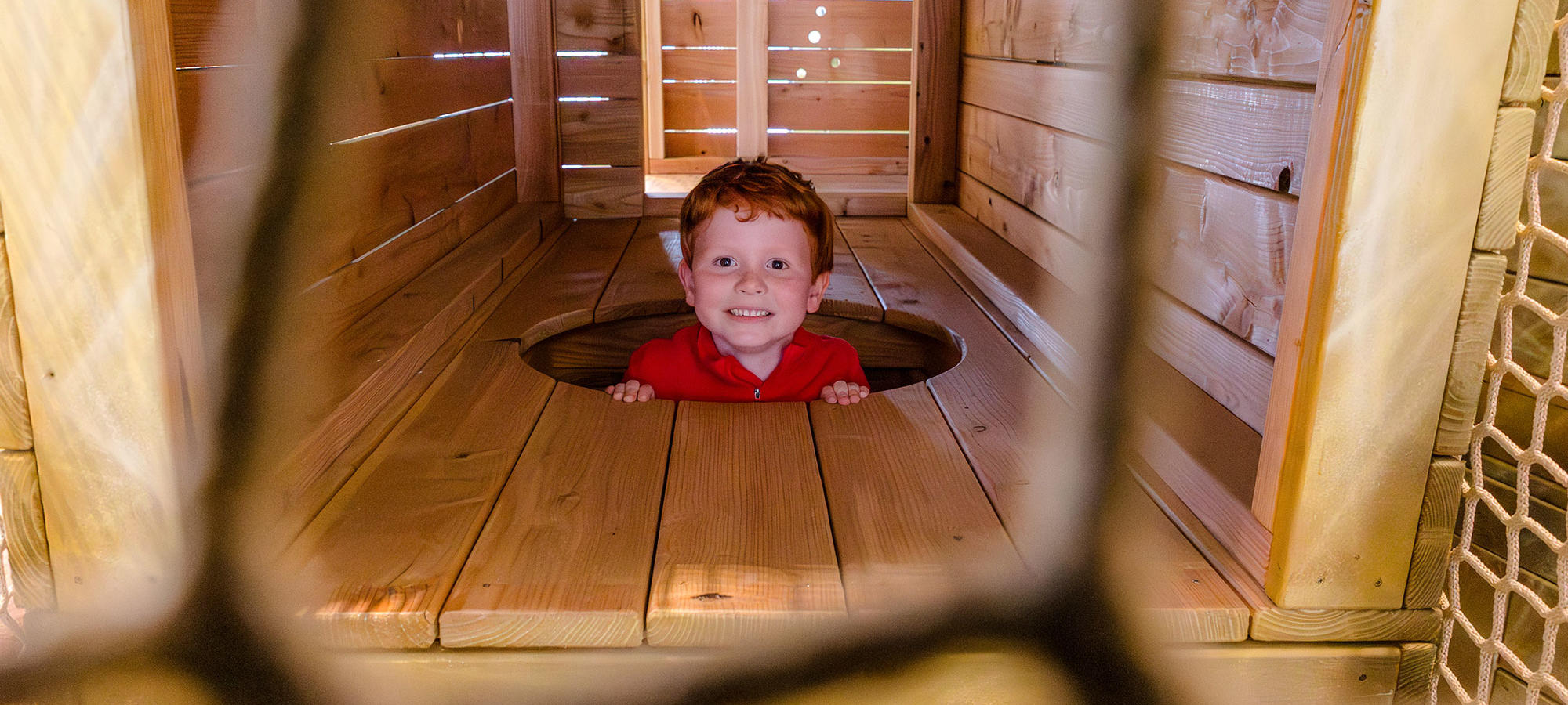 Young boy having fun in the Playbarn