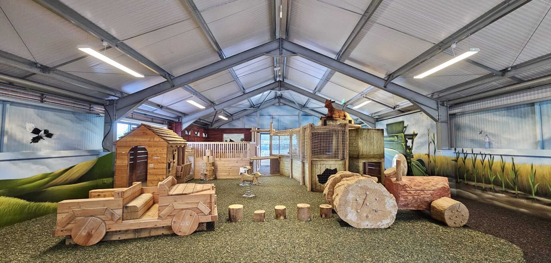 Indoor play barn with wooden play equipment